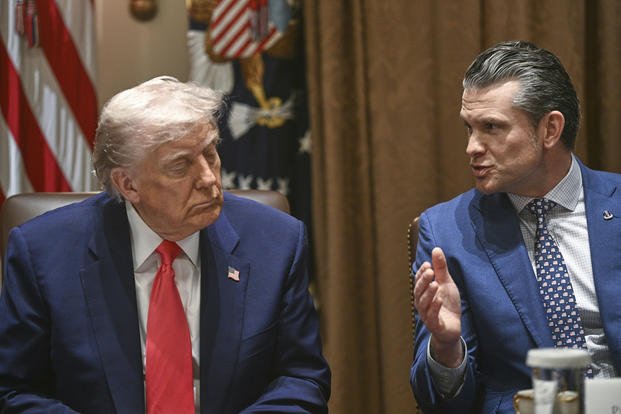 President  Trump listens as Defense Secretary Pete Hegseth speaks 