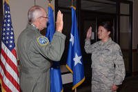 Retired Air Force Maj. Gen. Edward Mechenbier re-enlists his daughter, Master Sgt. Kari Eubanks, Air Force Reserve, 302nd Force Support Squadron, at Peterson Air Force Base, Colorado, Aug. 5, 2018. Mechenbier has re-enlisted Eubanks three times in her career and several others in this family over the years. (U.S. Air Force/Tiffany Lundberg)