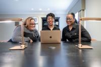 makeHER founders working on computer