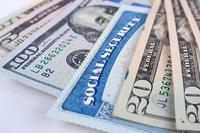 Social security card and American money dollar bills close up concept