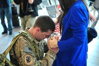 Senior Airman Joseph Tharp, a 9th Operations Support Squadron flight equipment technician, hugs his pregnant wife Sarah. (Photo: U.S. Air Force/Airman 1st Class Bobby Cummings)